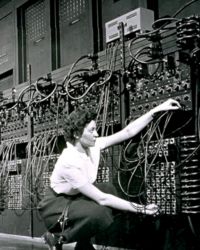 Vintage photo of woman using an old computer