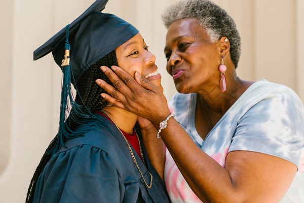 grandma kissing graduating student
