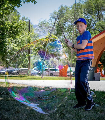 A boy makes a huge bubble at the Science in the Parks event.