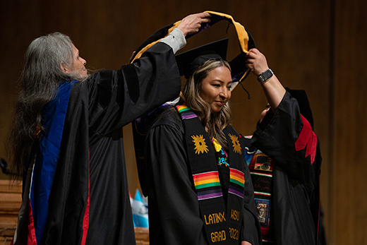 Christina Zamora is hooded at her graduation ceremony