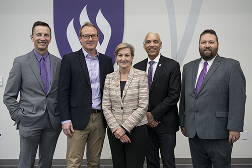 Weber State and NSA leadership pose for a picture.